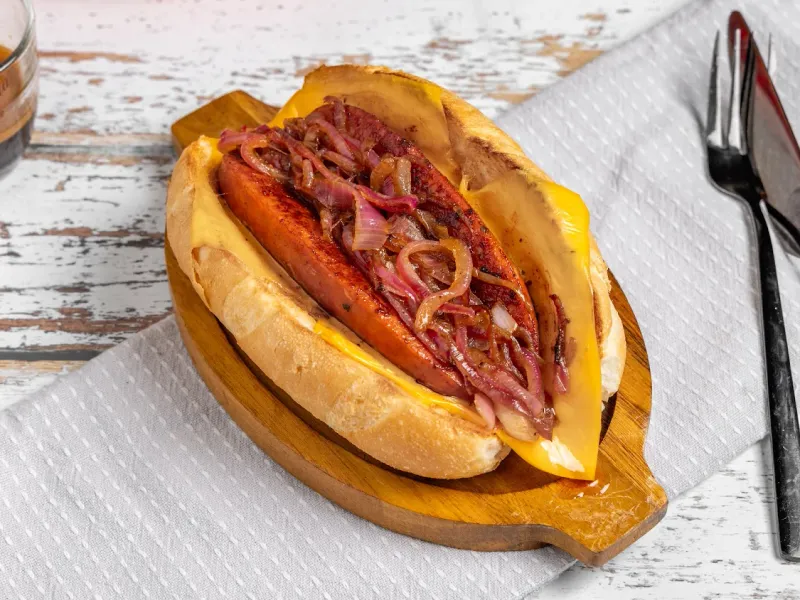 Grumpy Dads loaded sausage in a bun with caramelised onions