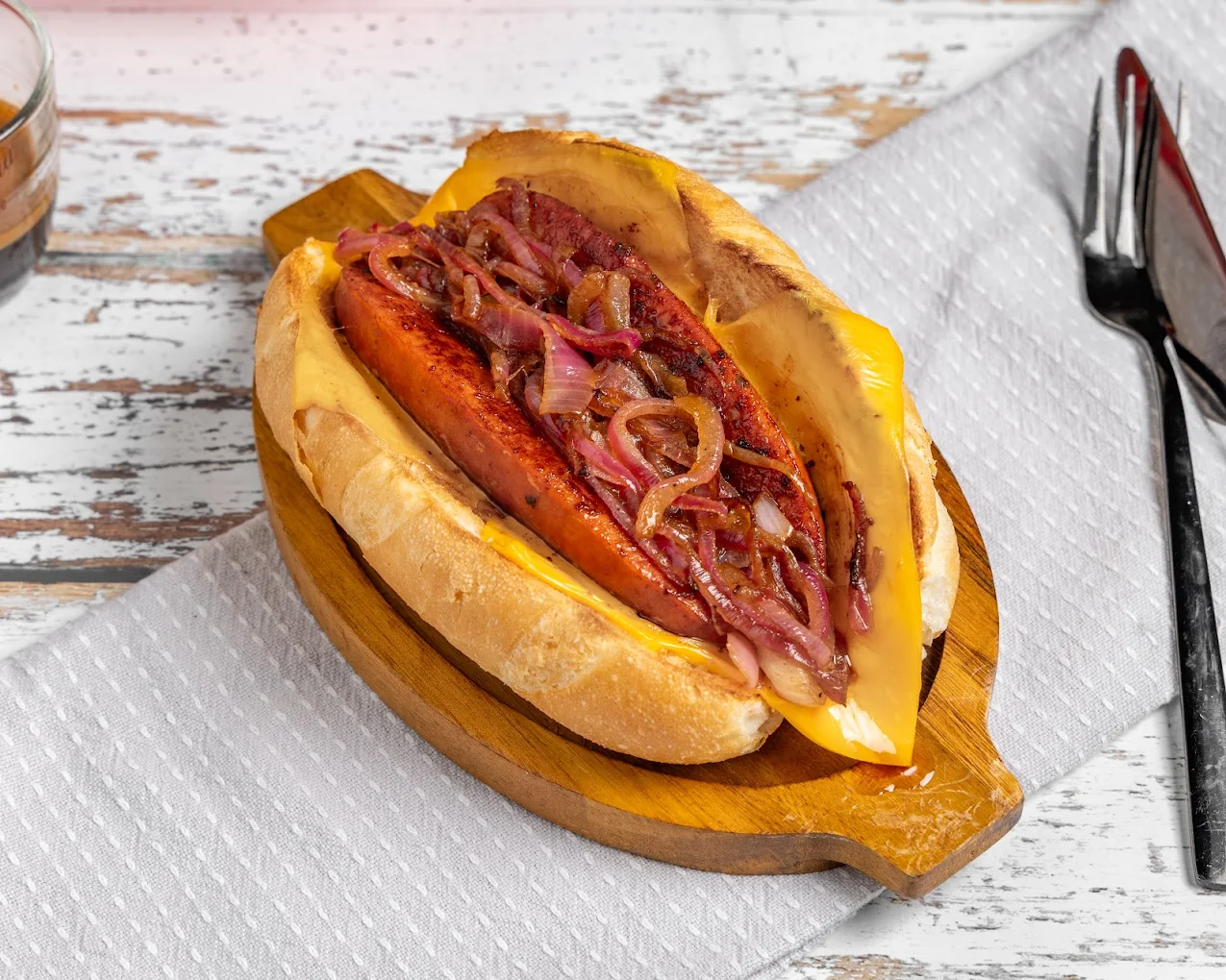 Grumpy Dads loaded sausage in a bun with caramelised onions